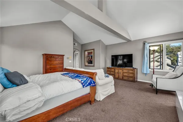 a bedroom with a bed and a couch