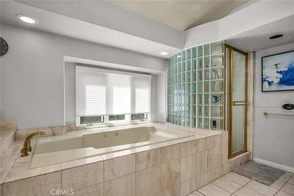 a spacious bathroom with a tub and sink