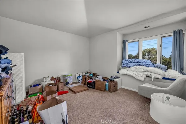 a bedroom with furniture and a large window