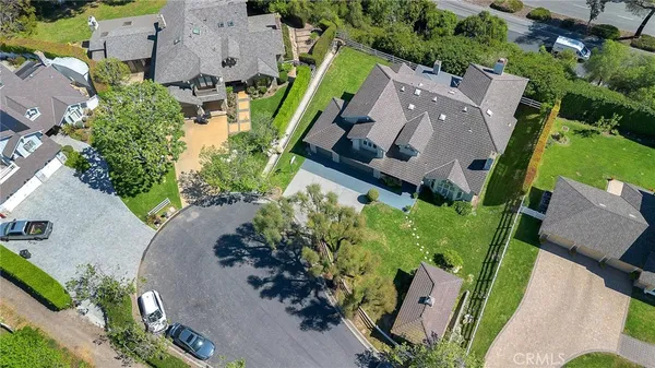 an aerial view of a house with a garden and yard