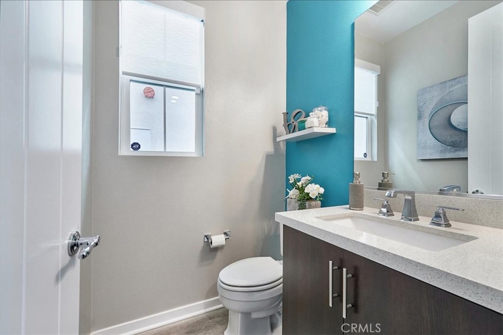 944 Sunlit Lane Costa Mesa, CA 92626 - Photo 20 of 71 a bathroom with a granite countertop toilet sink and mirror