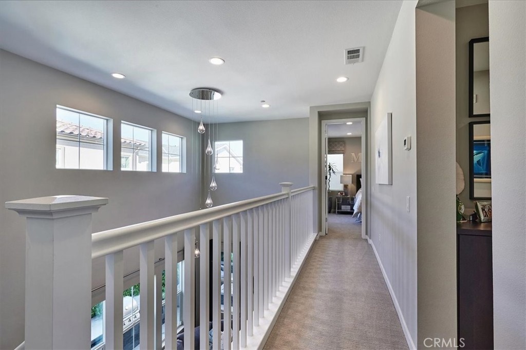 944 Sunlit Lane Costa Mesa, CA 92626 - Photo 27 of 71 a view of a hallway with a window and stairs