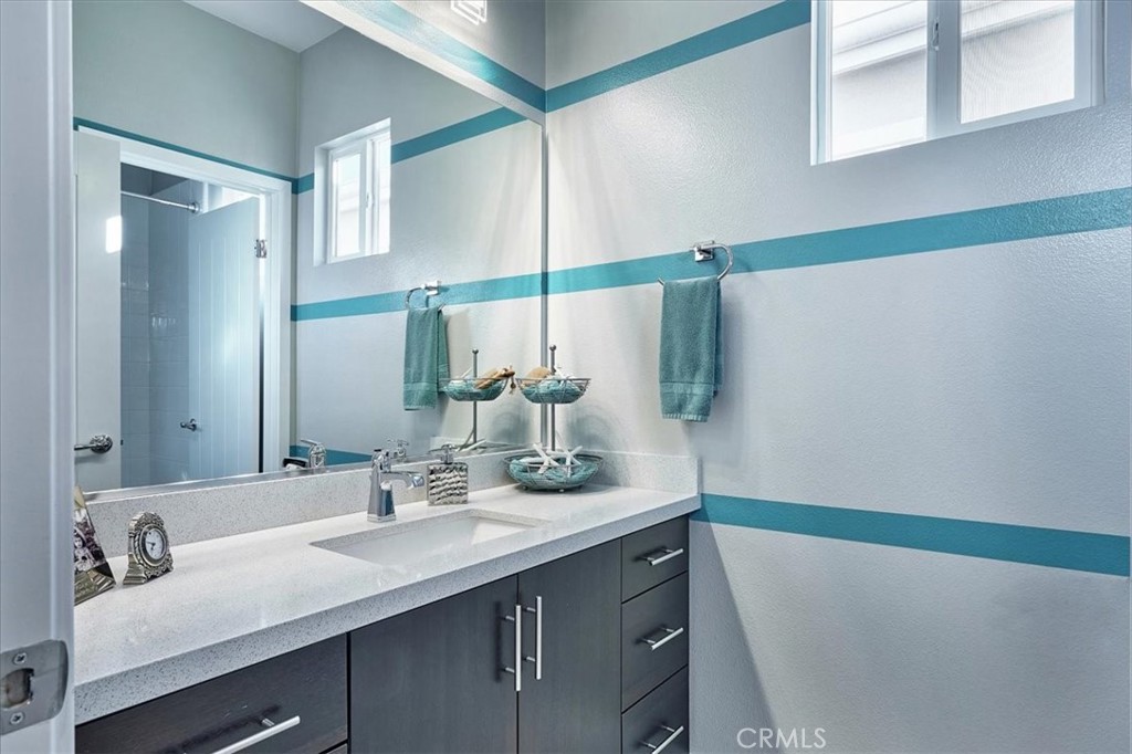 944 Sunlit Lane Costa Mesa, CA 92626 - Photo 42 of 71 a bathroom with a sink and a mirror
