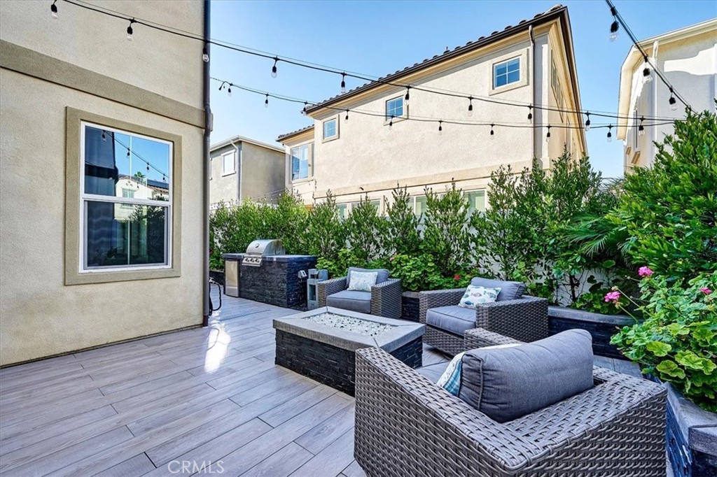 944 Sunlit Lane Costa Mesa, CA 92626 - Photo 59 of 71 a view of a patio with couches chairs potted plants and wooden floor