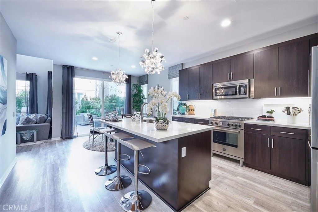 944 Sunlit Lane Costa Mesa, CA 92626 - Photo 6 of 71 a kitchen with kitchen island stainless steel appliances a sink stove and refrigerator