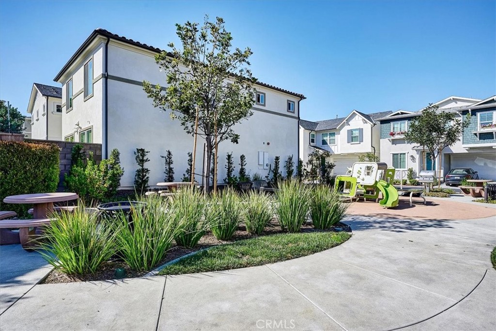 944 Sunlit Lane Costa Mesa, CA 92626 - Photo 69 of 71 a front view of a house with a garden