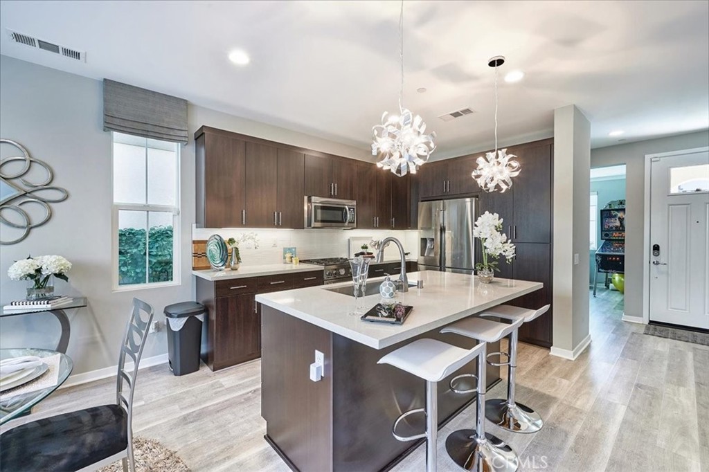 944 Sunlit Lane Costa Mesa, CA 92626 - Photo 9 of 71 a view of a dining room with furniture and chandelier