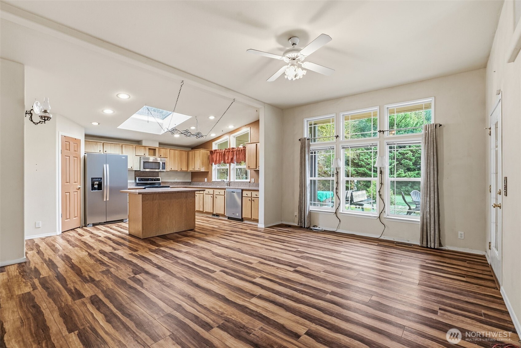 5416 Rose Valley Road Kelso, WA 98626 - Photo 17 of 28 a large kitchen with kitchen island a stove a sink dishwasher and white cabinets with wooden floor