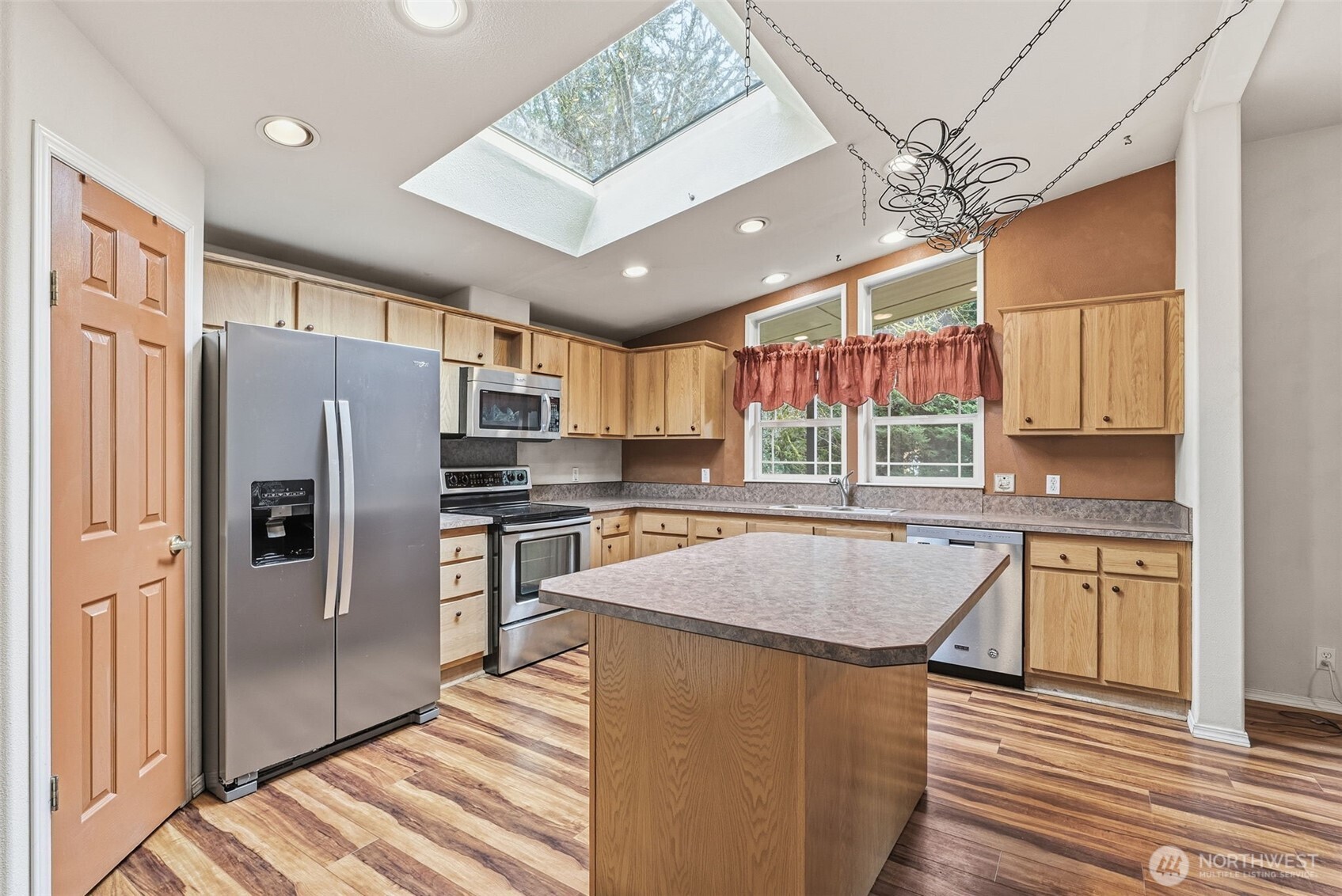 5416 Rose Valley Road Kelso, WA 98626 - Photo 19 of 28 a kitchen with stainless steel appliances granite countertop a refrigerator a sink dishwasher a stove and white cabinets with wooden floor