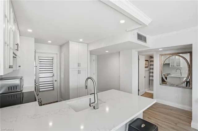 a kitchen with stainless steel appliances a sink and a refrigerator