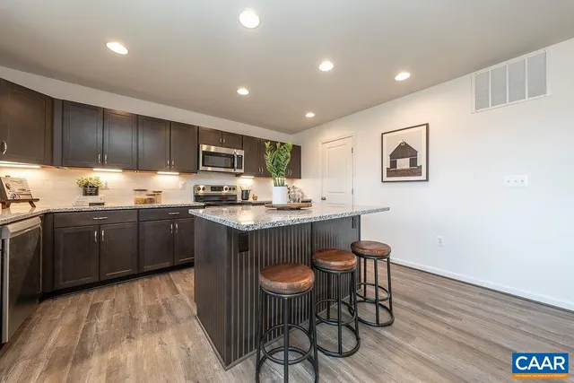 a kitchen with a sink cabinets and wooden floor