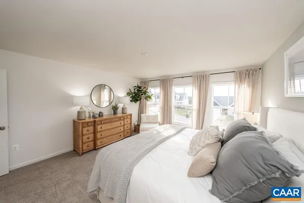 a bed room with a bed mirror and a window