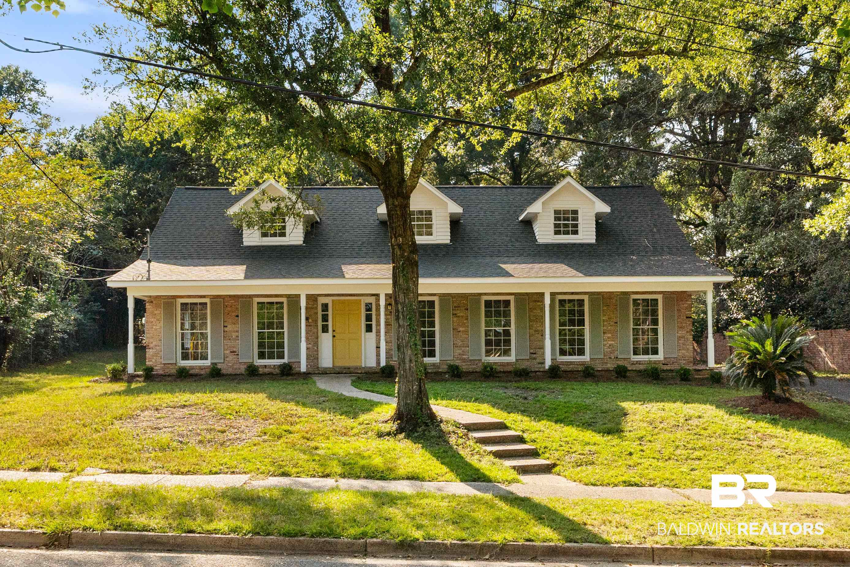 728 Spring Station Road Mobile, AL 36609 - Photo 32 of 35 New england style home with brick siding, a porch, a front yard, and a shingled roof