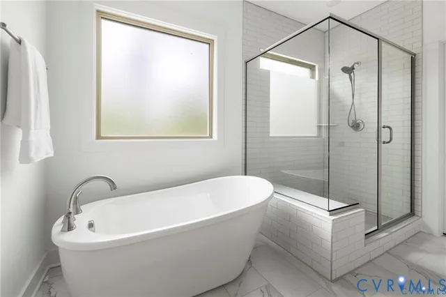 a white bath tub sitting next to a shower