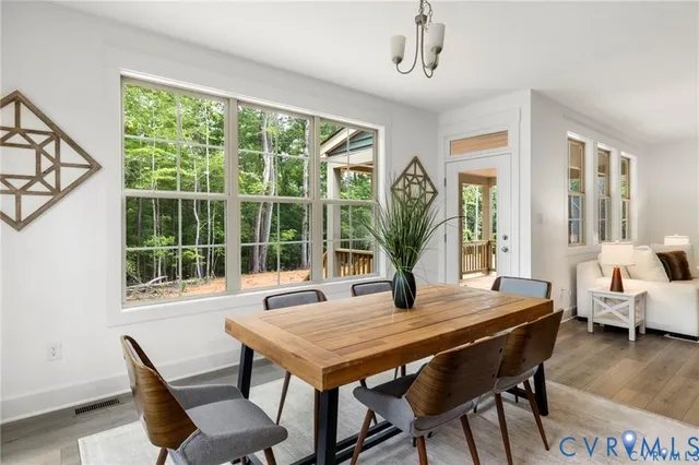 a view of a dining room with furniture window and wooden floor