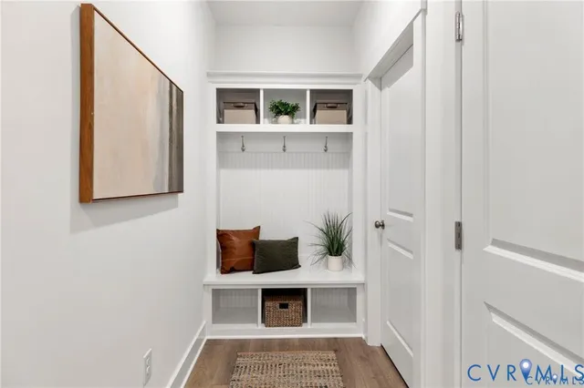 a kitchen with a table chairs microwave and cabinets