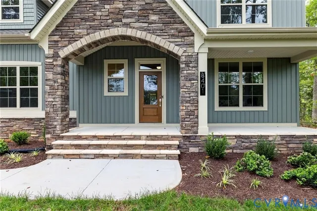 a front view of a house with plants