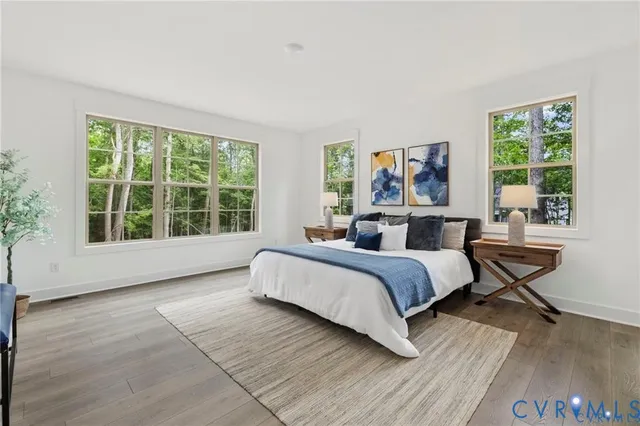 a spacious bedroom with a bed and a large window