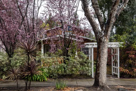 a view of a house with a tree