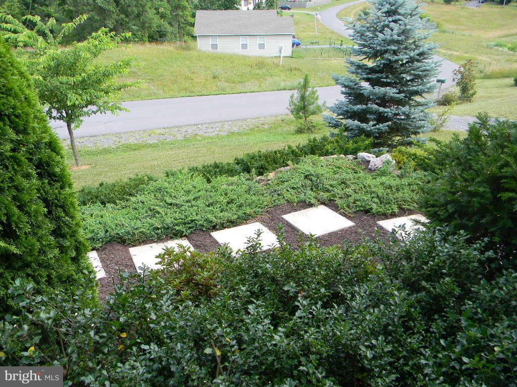 115 Lair Way Inwood, WV 25428 - Photo 13 of 28 a backyard of a house with a yard and outdoor seating