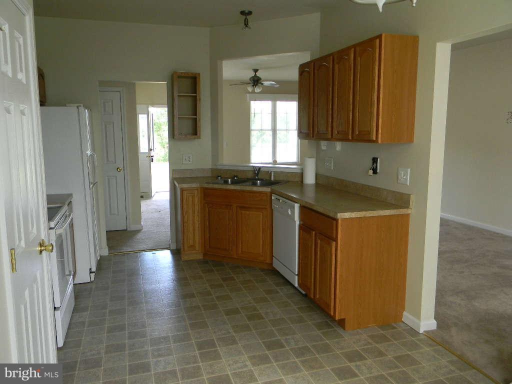 115 Lair Way Inwood, WV 25428 - Photo 16 of 28 a kitchen with stainless steel appliances granite countertop a stove a sink and a refrigerator