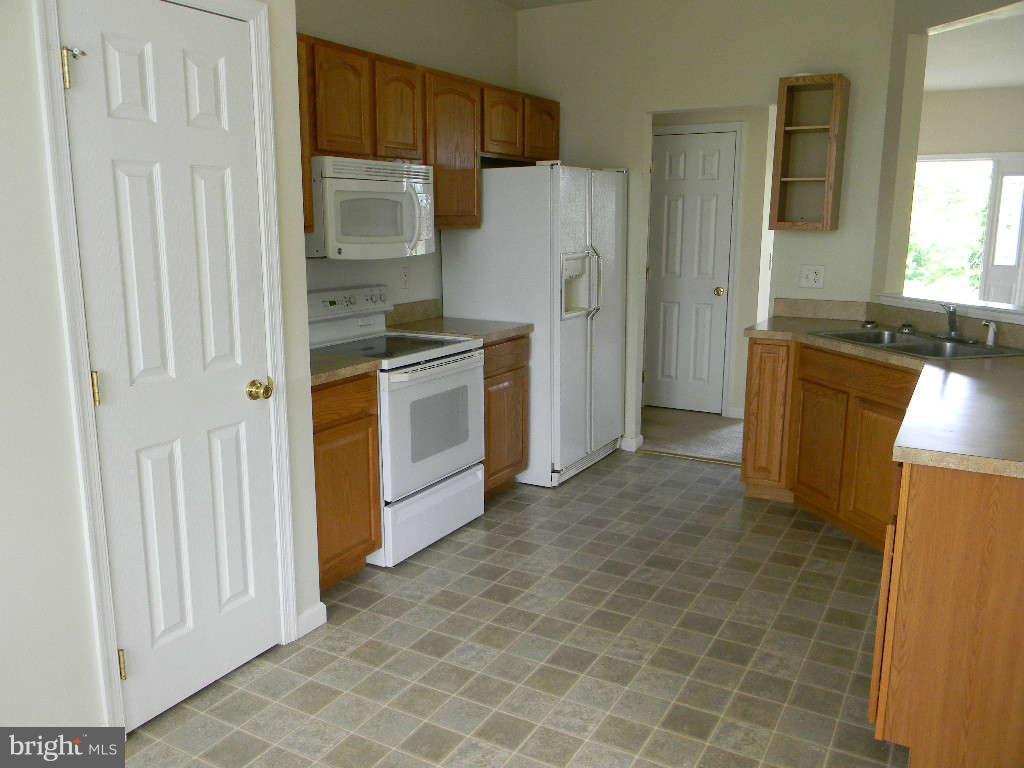 115 Lair Way Inwood, WV 25428 - Photo 17 of 28 a kitchen with stainless steel appliances granite countertop a refrigerator and a sink