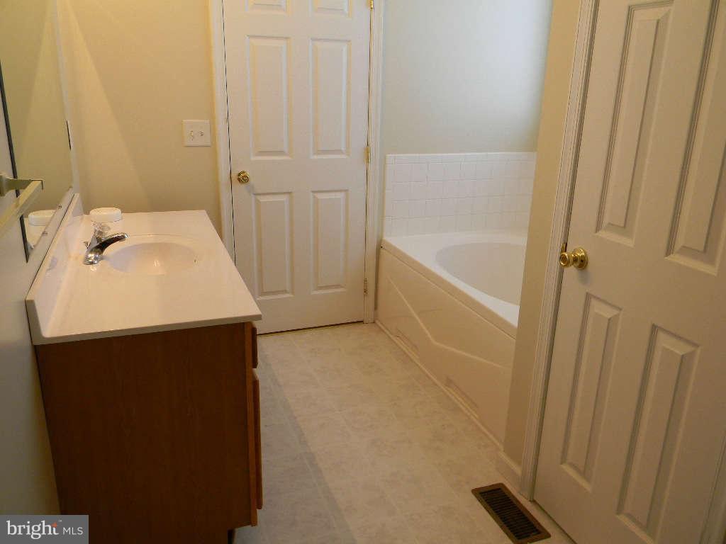 115 Lair Way Inwood, WV 25428 - Photo 21 of 28 a bathroom with a sink and a bathtub