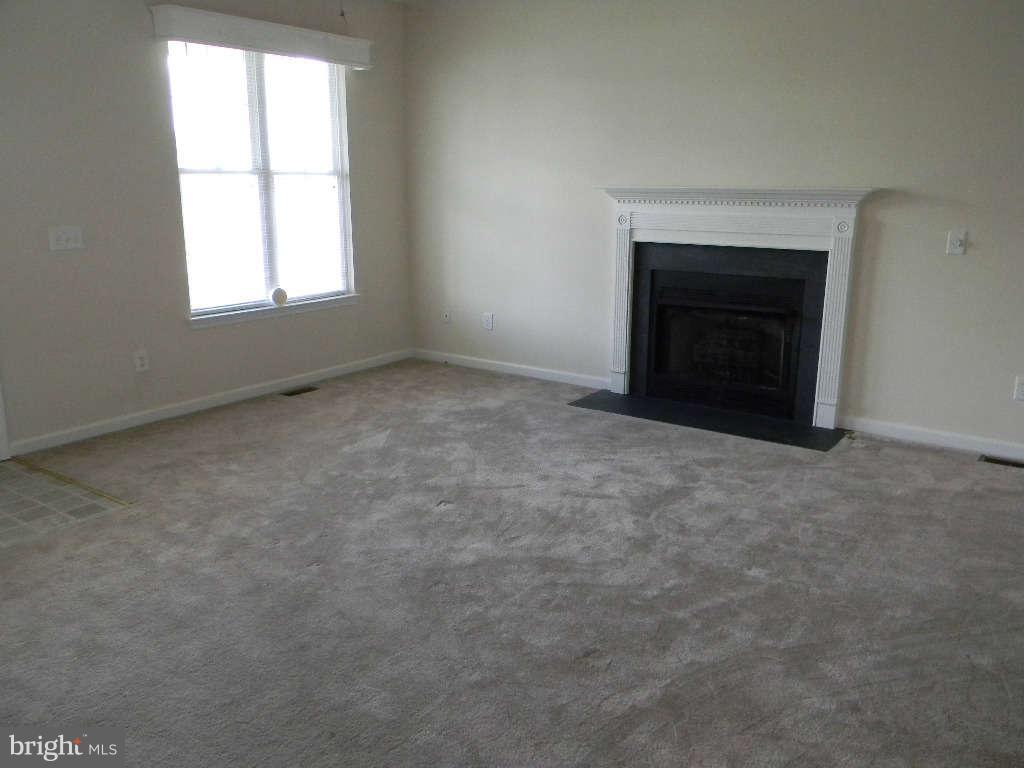 115 Lair Way Inwood, WV 25428 - Photo 23 of 28 an empty room with a fireplace