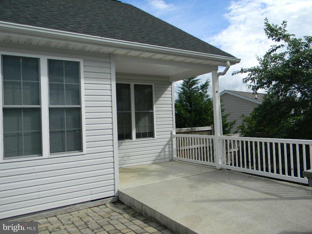 115 Lair Way Inwood, WV 25428 - Photo 5 of 28 a view of a porch with a floor to ceiling window and wooden fence