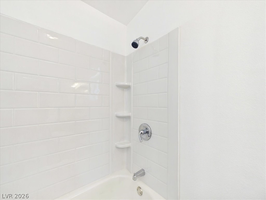 4081 Retread Road Pahrump, NV 89048 - Photo 32 of 98 A pristine bathtub with subway tile surround awaits tranquil bathing experiences.
