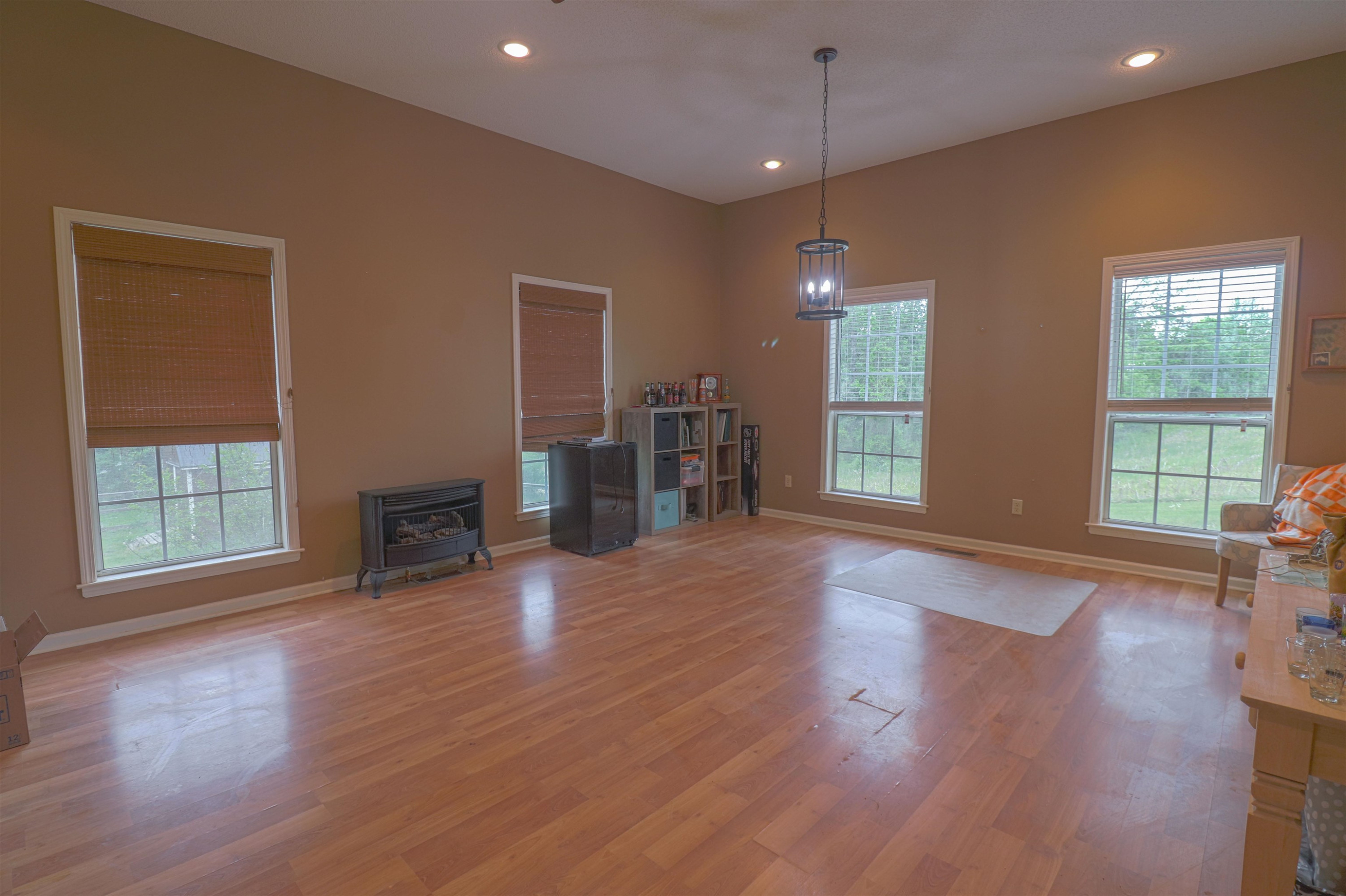 4934 Asbury Glimp Road Ripley, TN 38063 - Photo 16 of 25 an empty room with wooden floor and windows