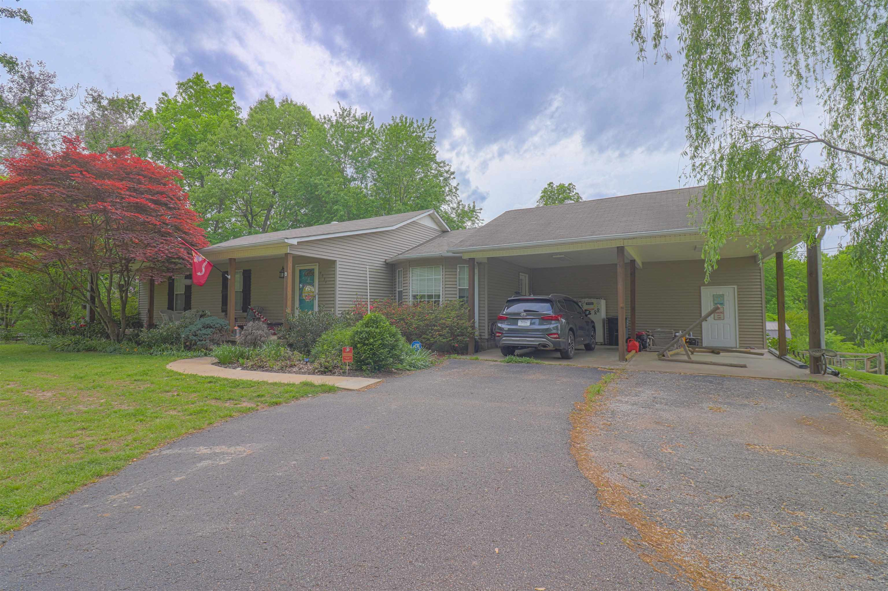 4934 Asbury Glimp Road Ripley, TN 38063 - Photo 2 of 25 front view of a house with a yard and potted plants