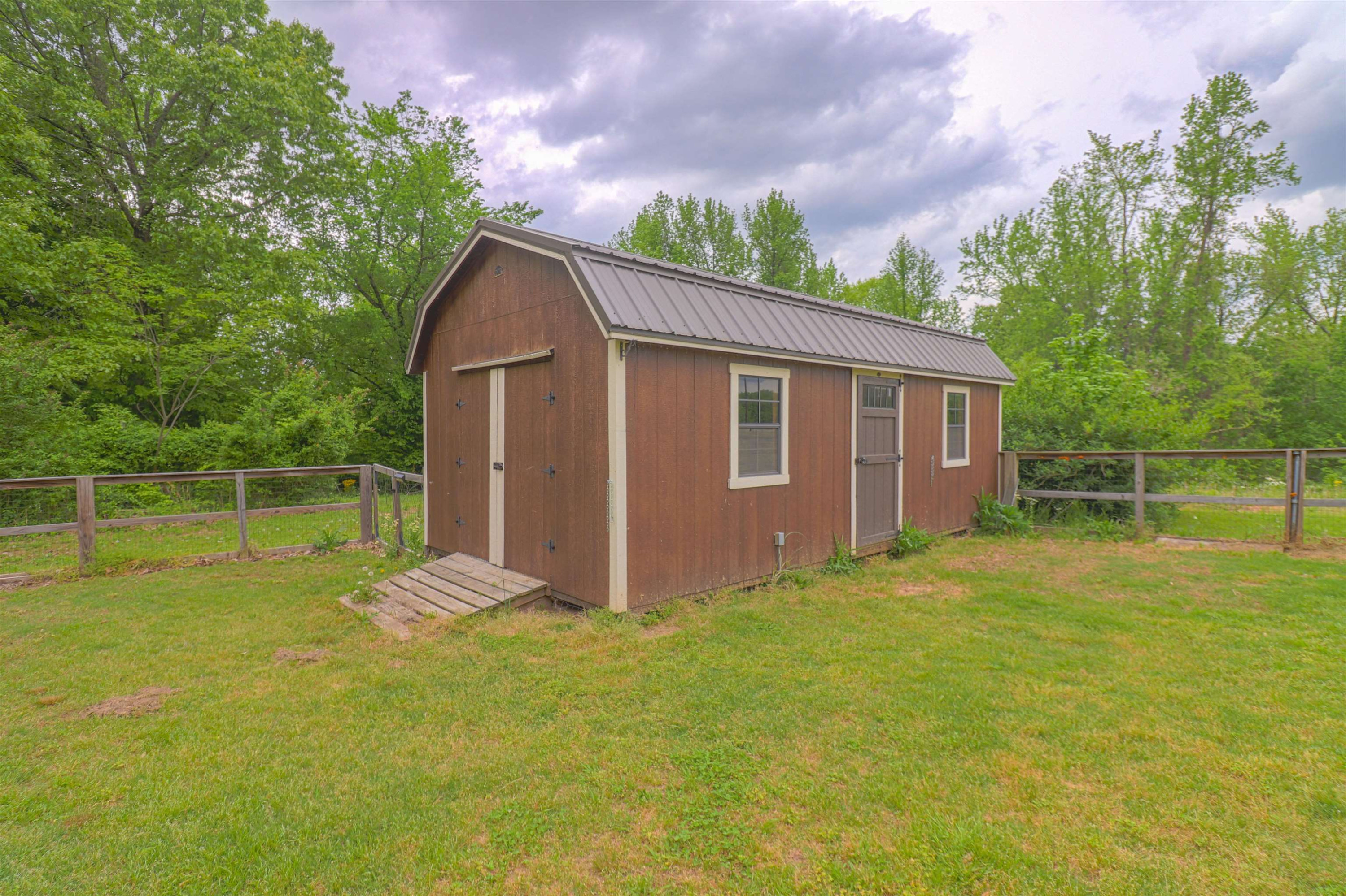 4934 Asbury Glimp Road Ripley, TN 38063 - Photo 21 of 25 a backyard of a house with plants and large tree