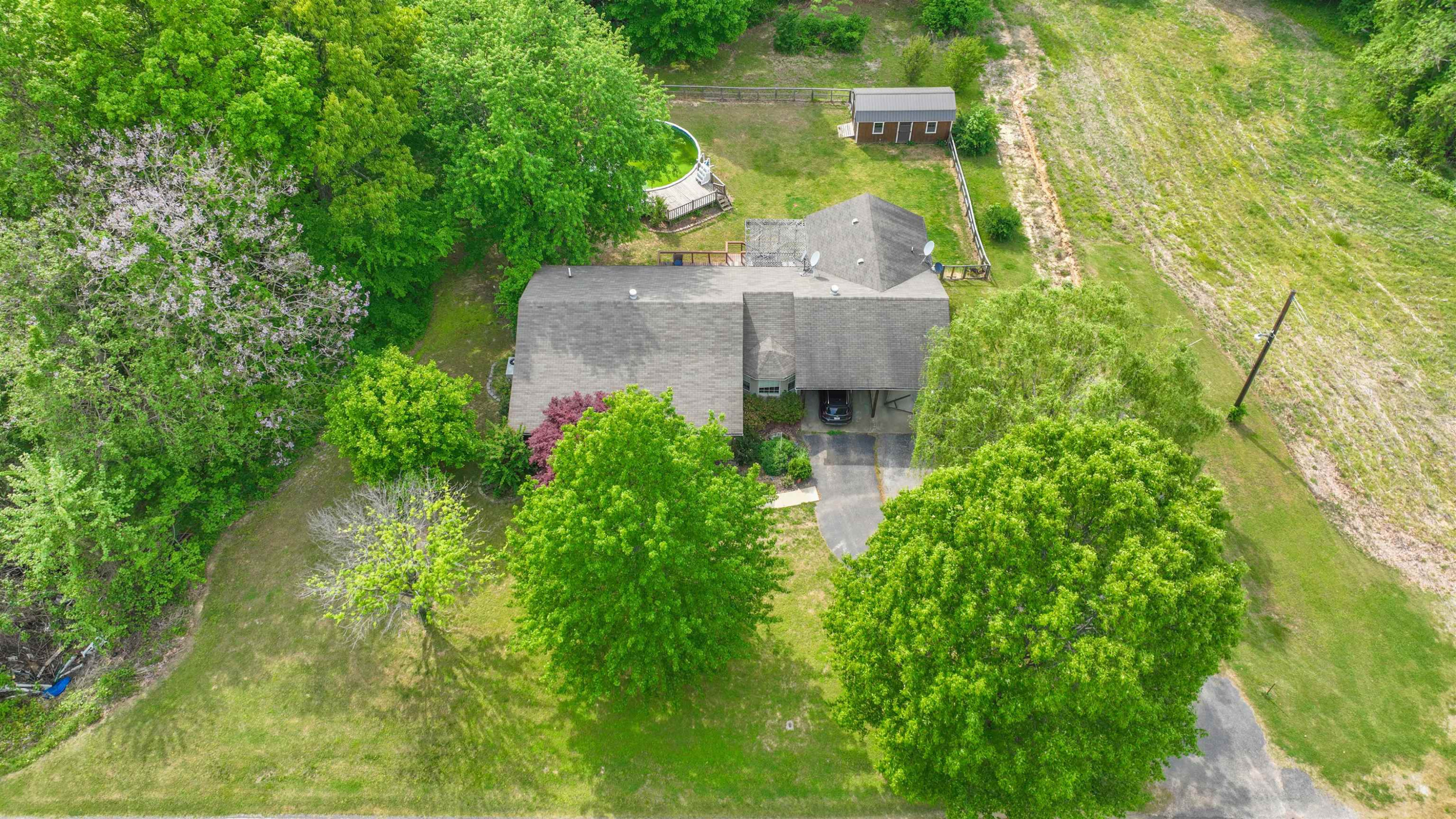 4934 Asbury Glimp Road Ripley, TN 38063 - Photo 23 of 25 an aerial view of a house with swimming pool and garden