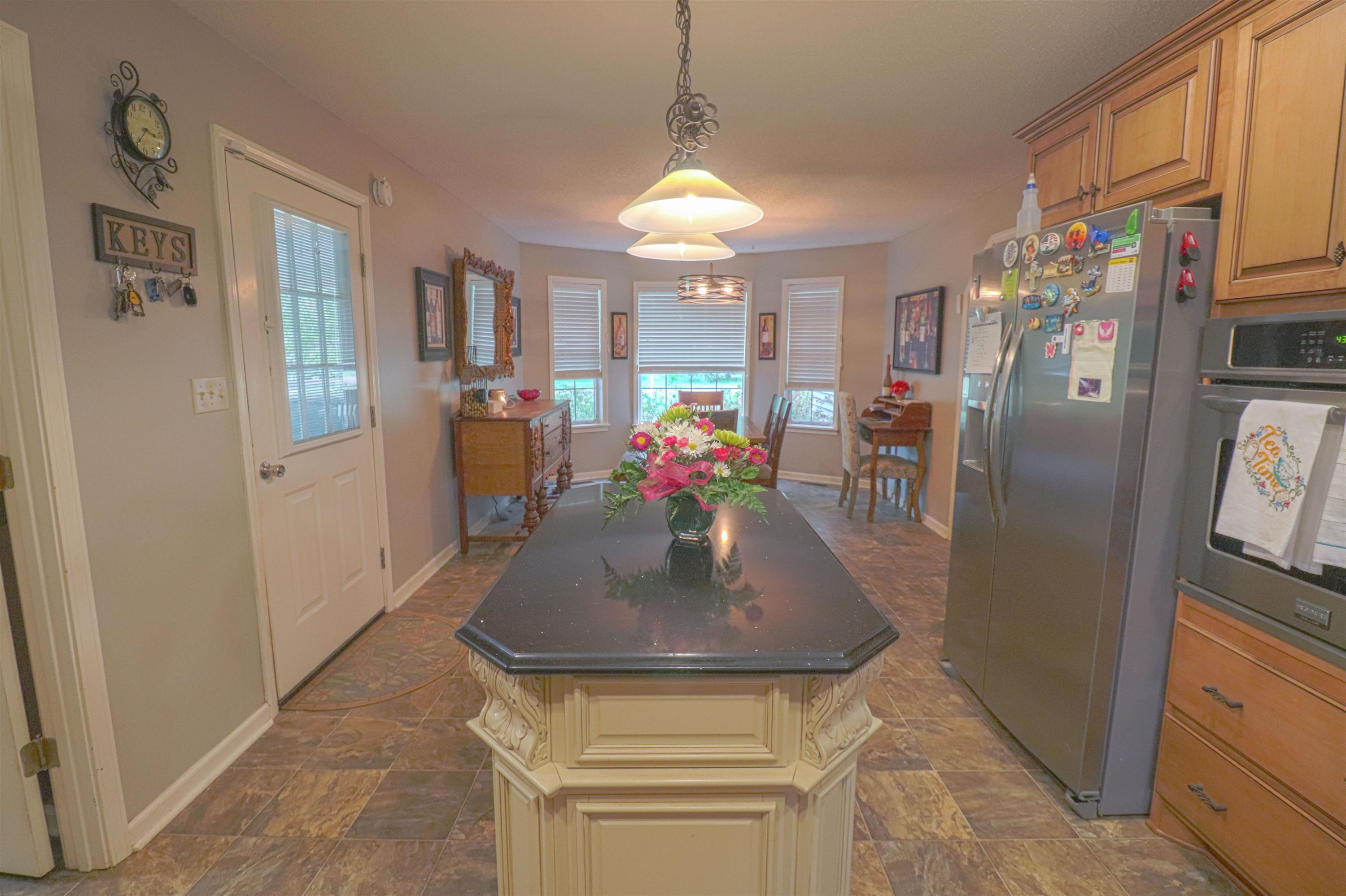 4934 Asbury Glimp Road Ripley, TN 38063 - Photo 5 of 25 a view of kitchen island with furniture and refrigerator