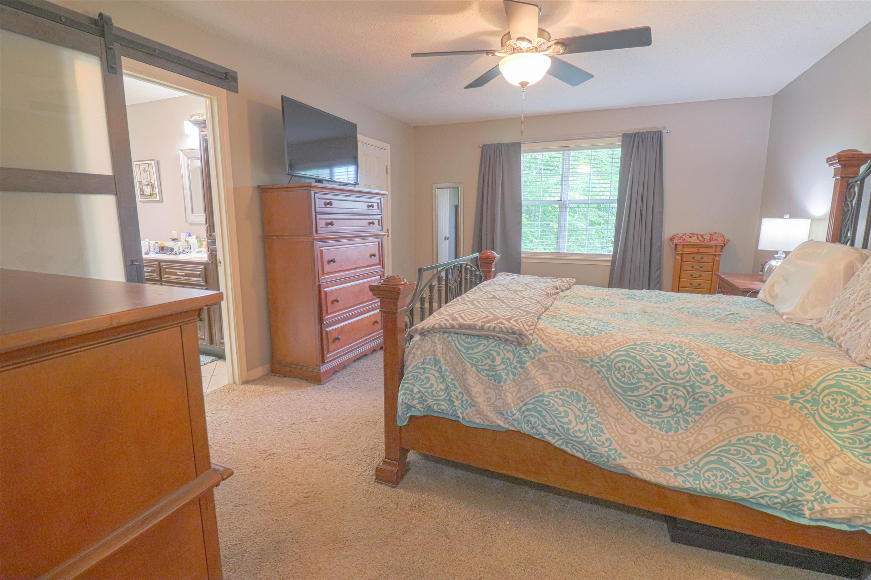 4934 Asbury Glimp Road Ripley, TN 38063 - Photo 8 of 25 a bedroom with a bed dresser and a window