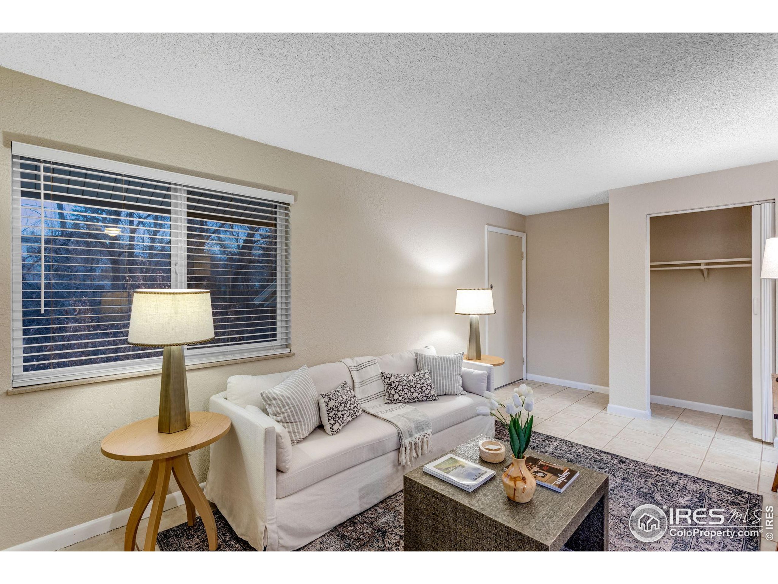 1705 Heatheridge Road Fort Collins, CO 80526 - Photo 8 of 21 a living room with furniture a lamp and a table
