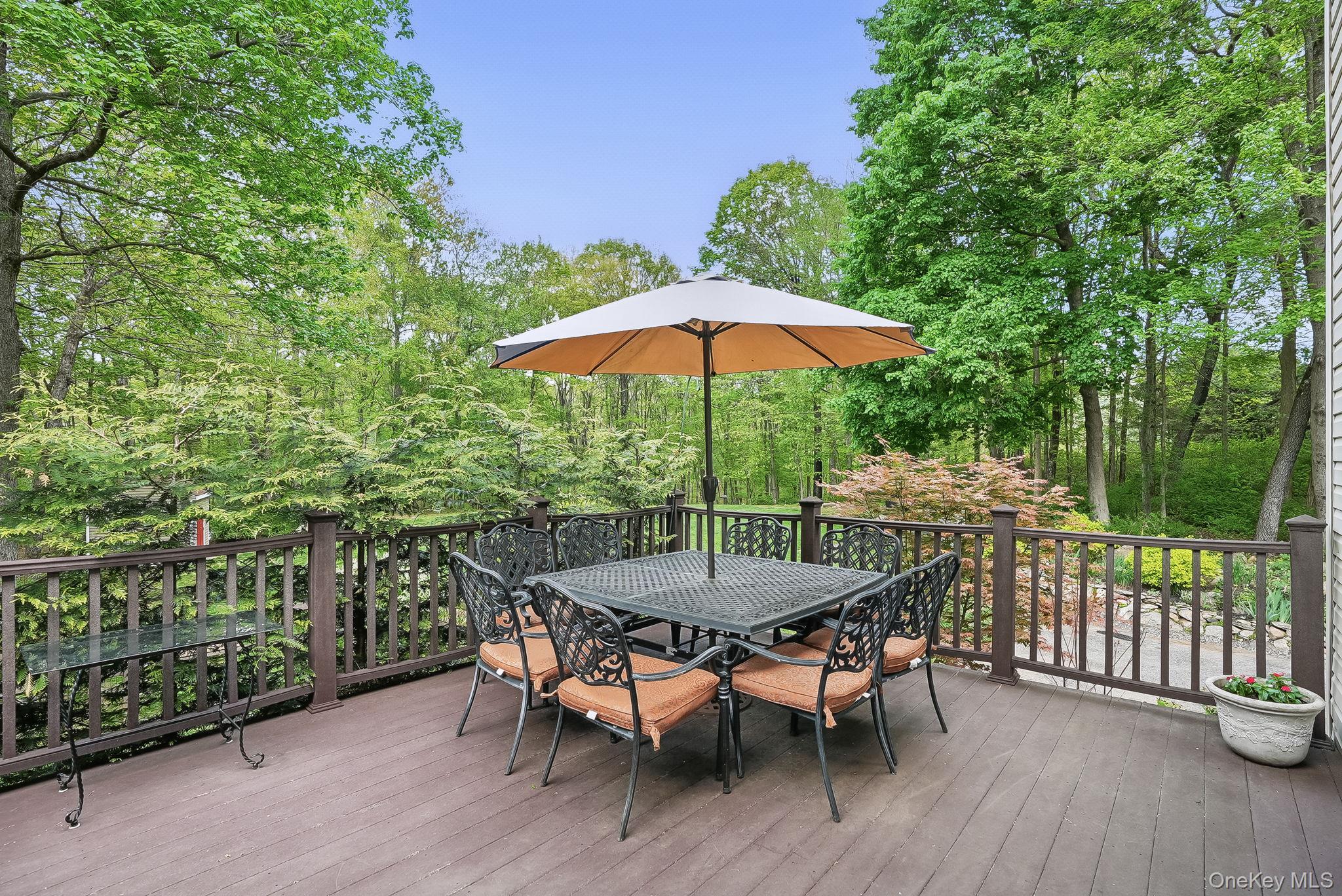 304 Church Road Putnam Valley, NY 10579 - Photo 35 of 50 Wooden terrace with outdoor dining space and view of wooded area