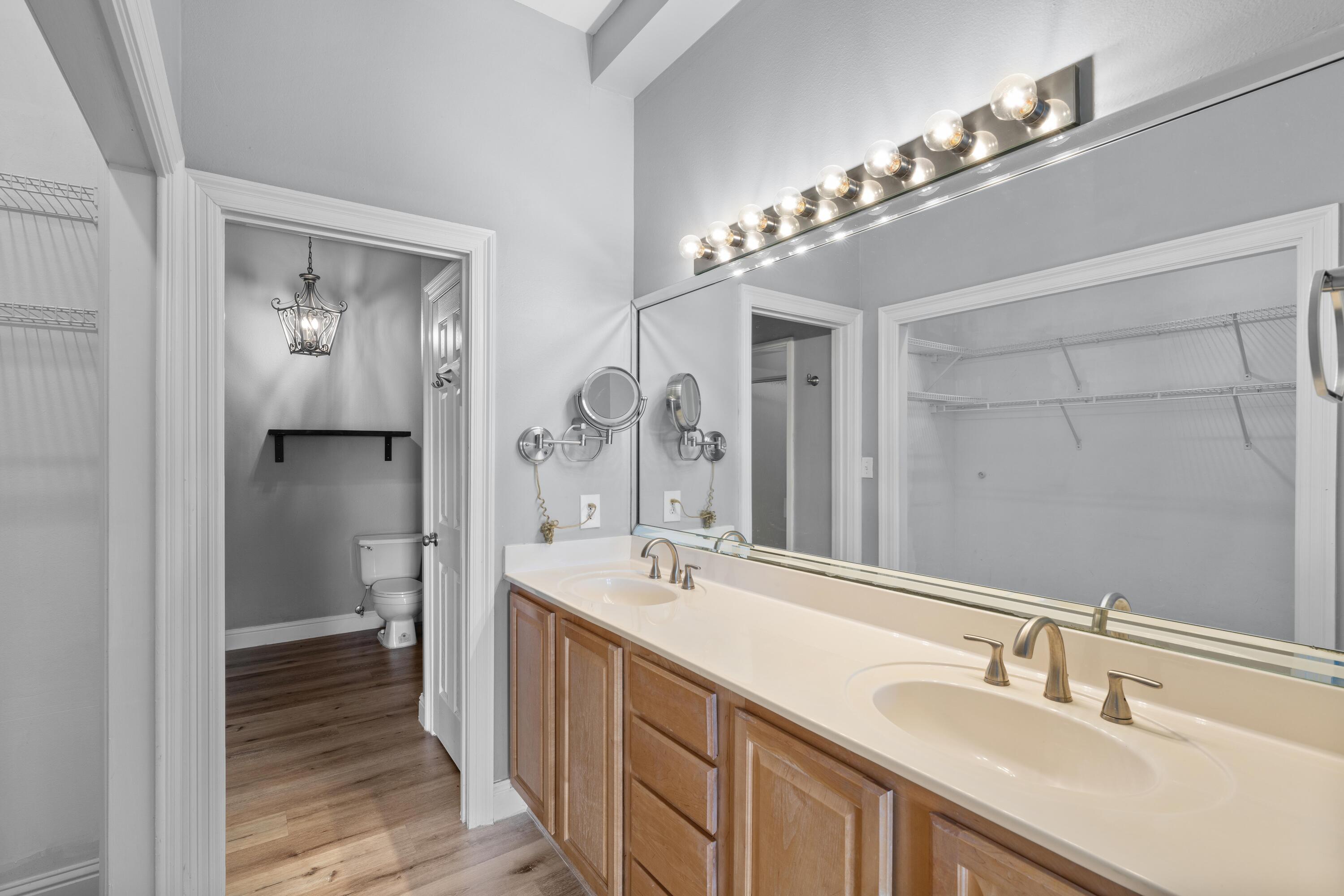 4507 Furling Lane, Unit 302 Destin, FL 32541 - Photo 26 of 49 a bathroom with a double vanity sink and a mirror