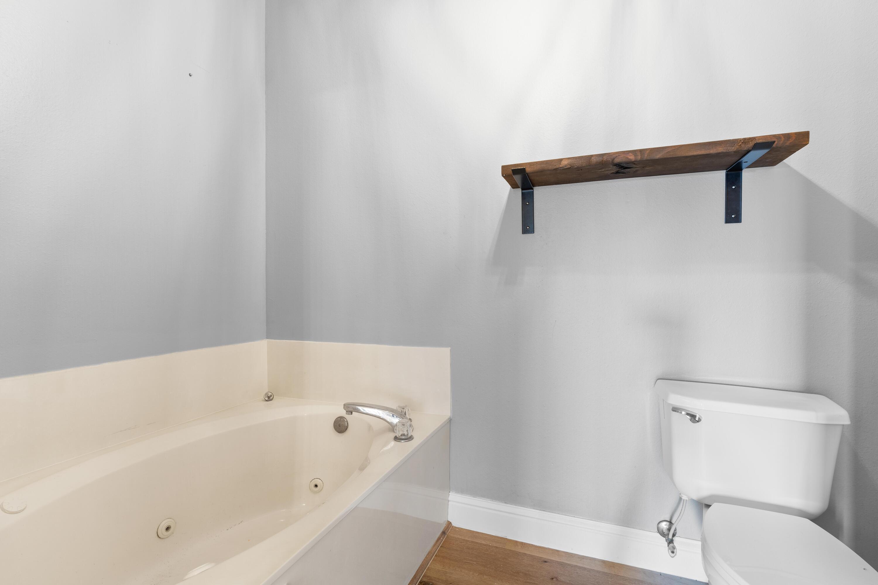 4507 Furling Lane, Unit 302 Destin, FL 32541 - Photo 29 of 49 a white bath tub sitting next to a toilet