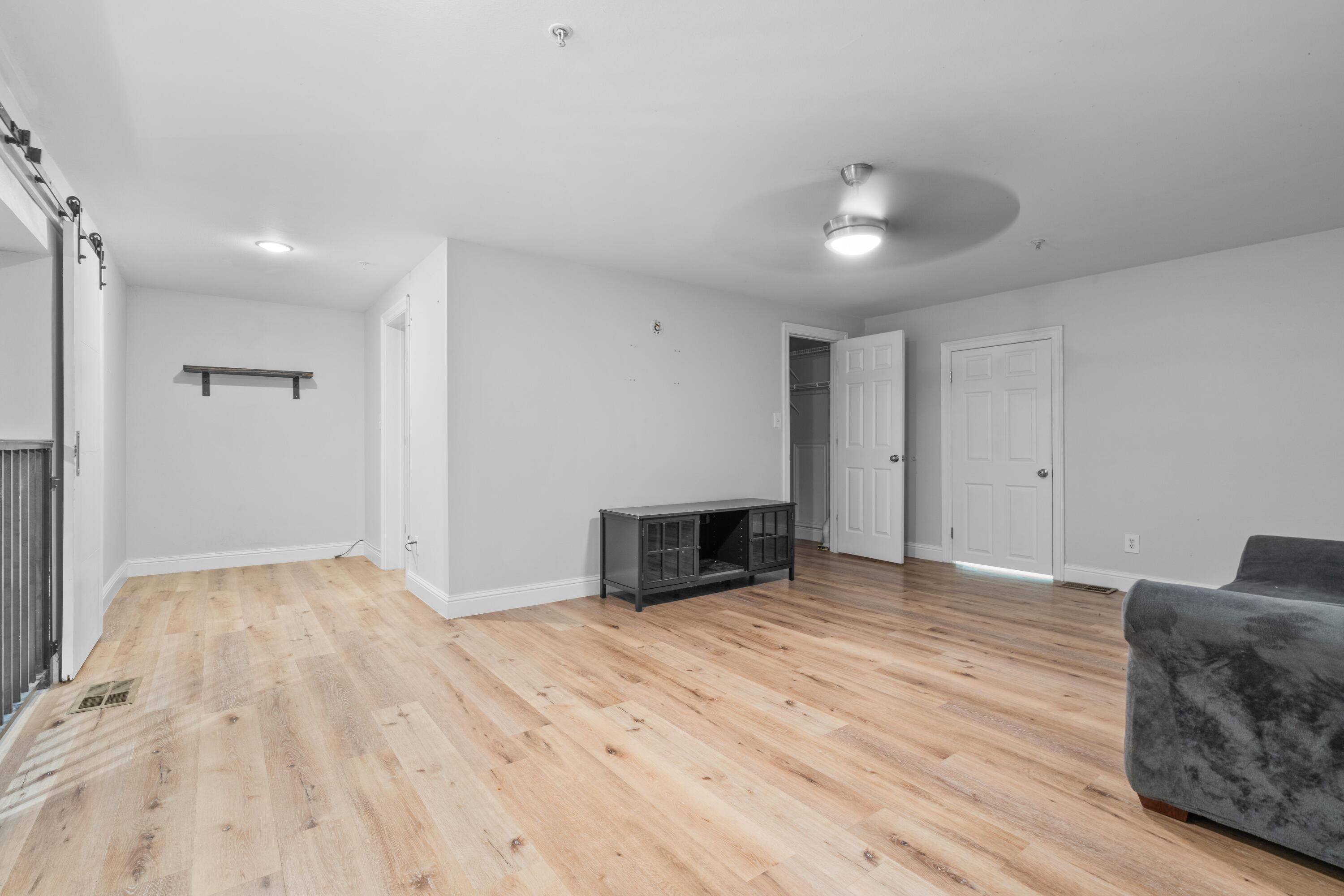 4507 Furling Lane, Unit 302 Destin, FL 32541 - Photo 32 of 49 a view of empty room with wooden floor and fan