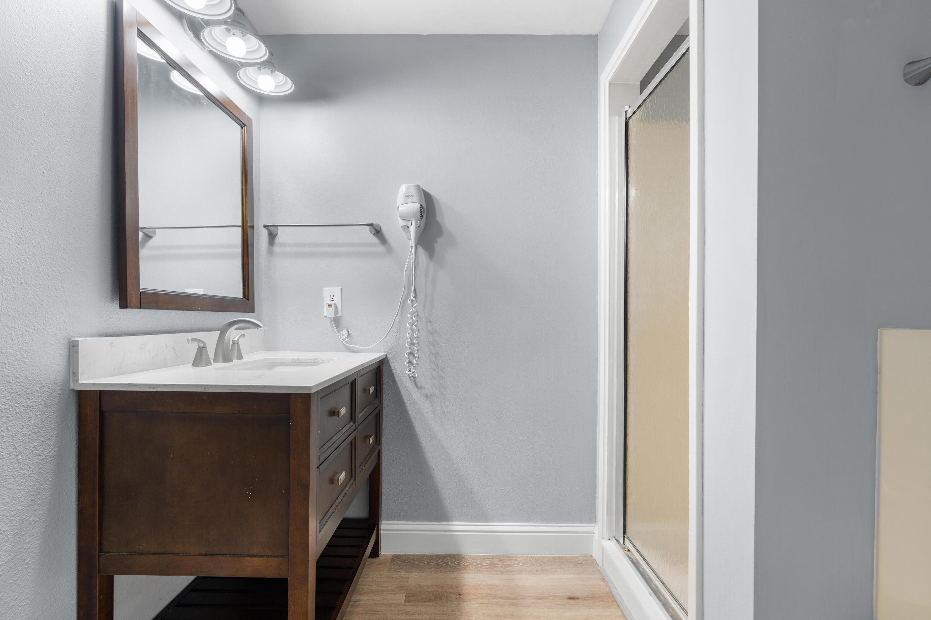 4507 Furling Lane, Unit 302 Destin, FL 32541 - Photo 35 of 49 a bathroom with a sink and a mirror