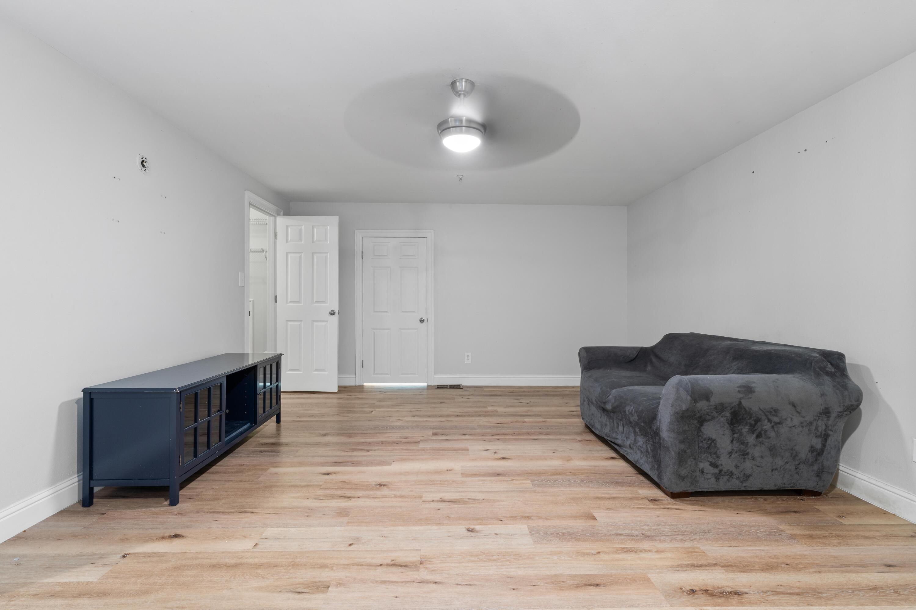 4507 Furling Lane, Unit 302 Destin, FL 32541 - Photo 38 of 49 a living room with furniture and a wooden floor