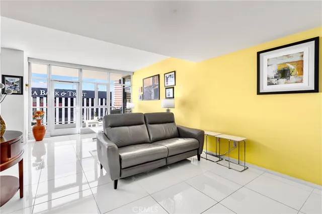 a living room with furniture and a wall painting