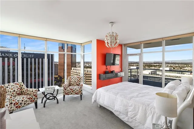 a bedroom with furniture and large windows