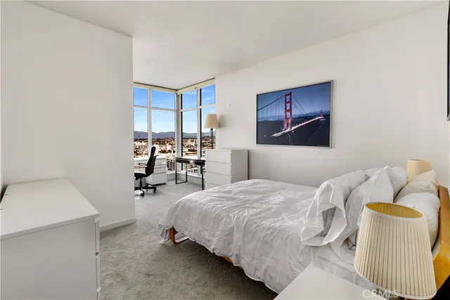 a bedroom with a bed and a chair