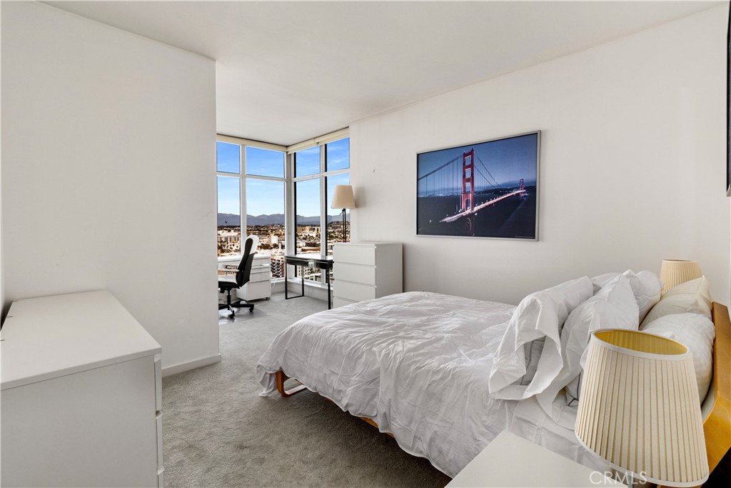 400 West Ocean Boulevard, Unit 2004 Long Beach, CA 90802 - Photo 21 of 47 a bedroom with a bed and a chair