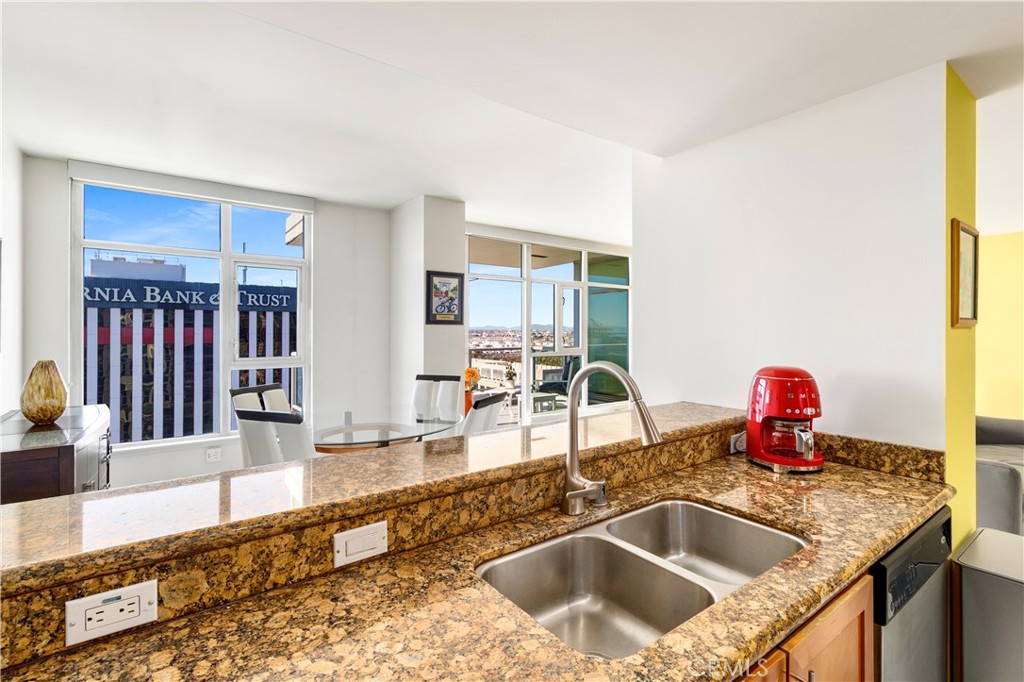 400 West Ocean Boulevard, Unit 2004 Long Beach, CA 90802 - Photo 6 of 47 a kitchen with granite countertop a sink and a granite counter top