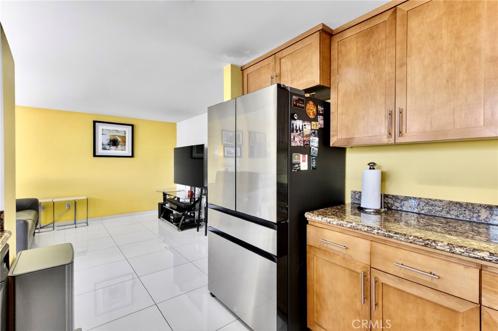 400 West Ocean Boulevard, Unit 2004 Long Beach, CA 90802 - Photo 8 of 47 a kitchen with stainless steel appliances granite countertop a refrigerator and a stove top oven