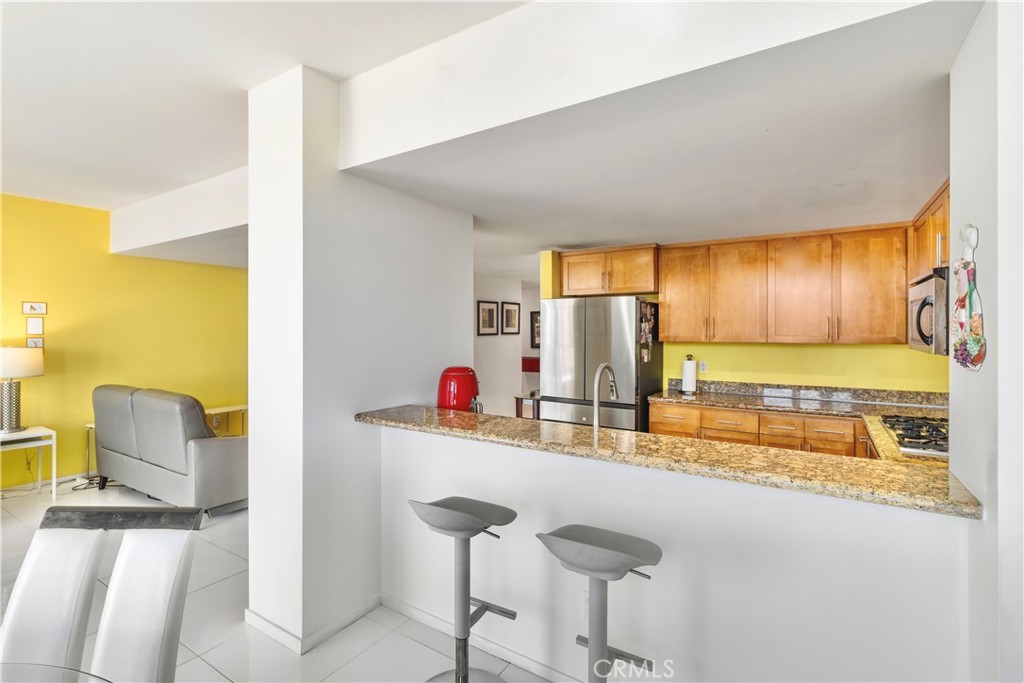 400 West Ocean Boulevard, Unit 2004 Long Beach, CA 90802 - Photo 9 of 47 a kitchen with a sink and a refrigerator